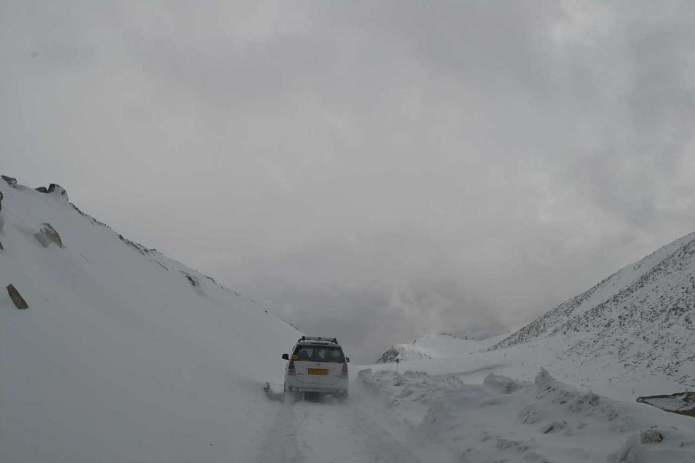 A vehicle on a snow-covered Ladakh mountain road